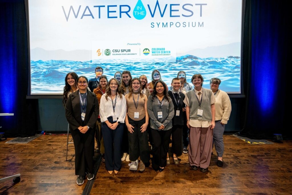 Group photo in front of a screen with the Water in the West logo.